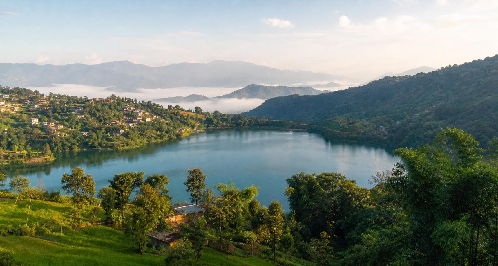 Mountain villages surrounding a peaceful lake in Nepal